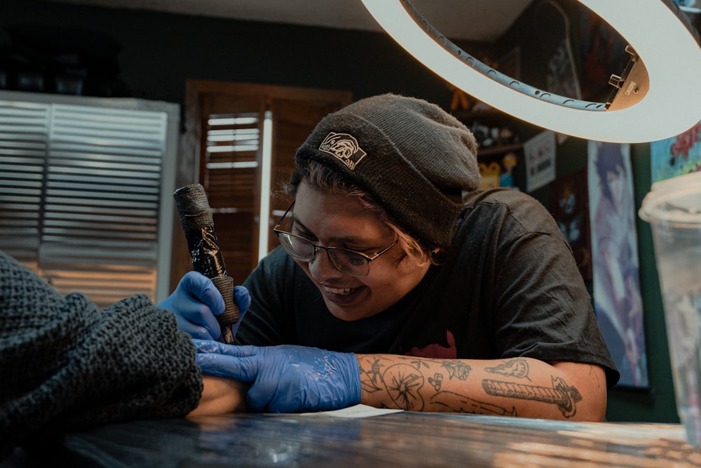 a man getting a tattoo on his arm