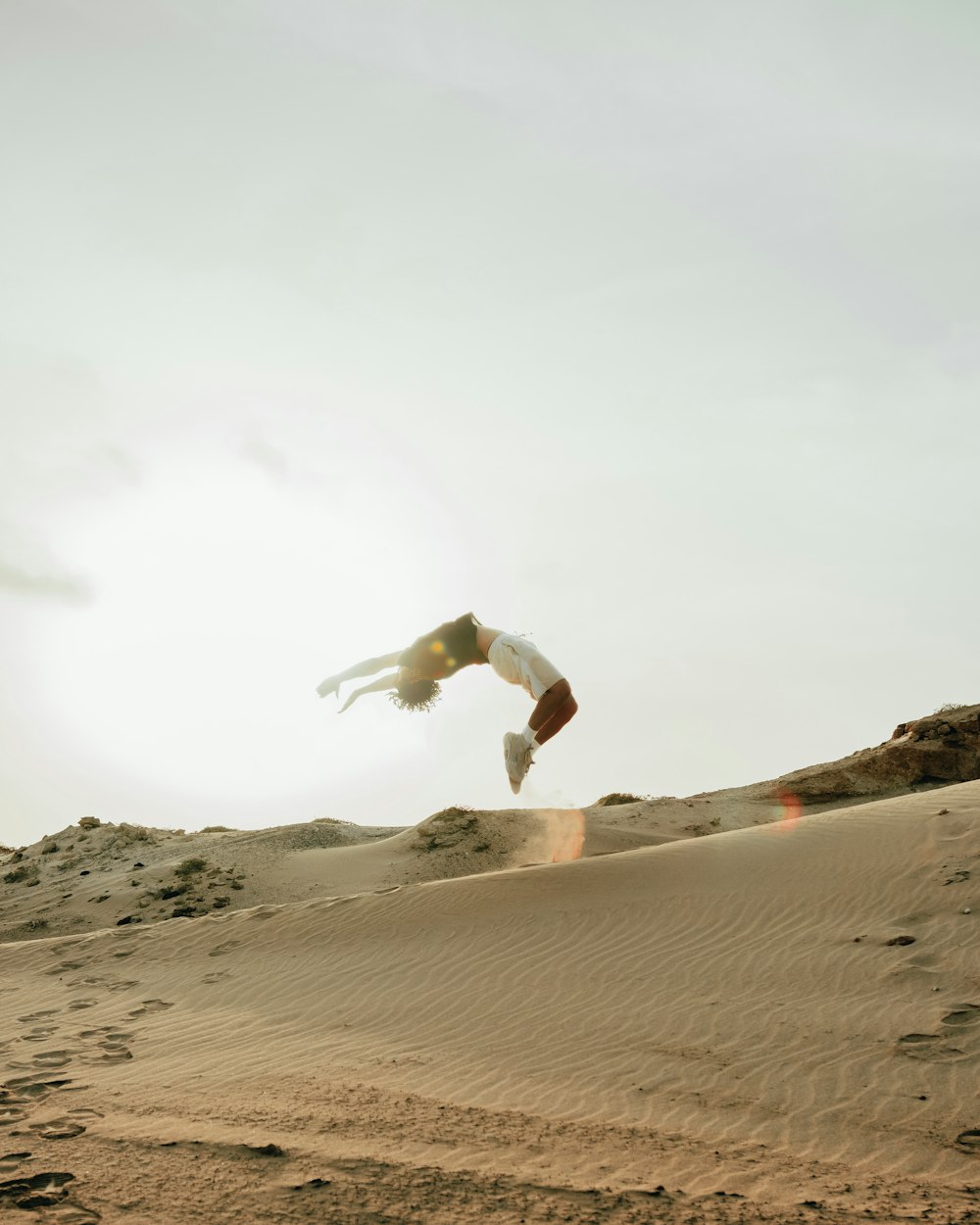 a man flying through the air while riding a skateboard