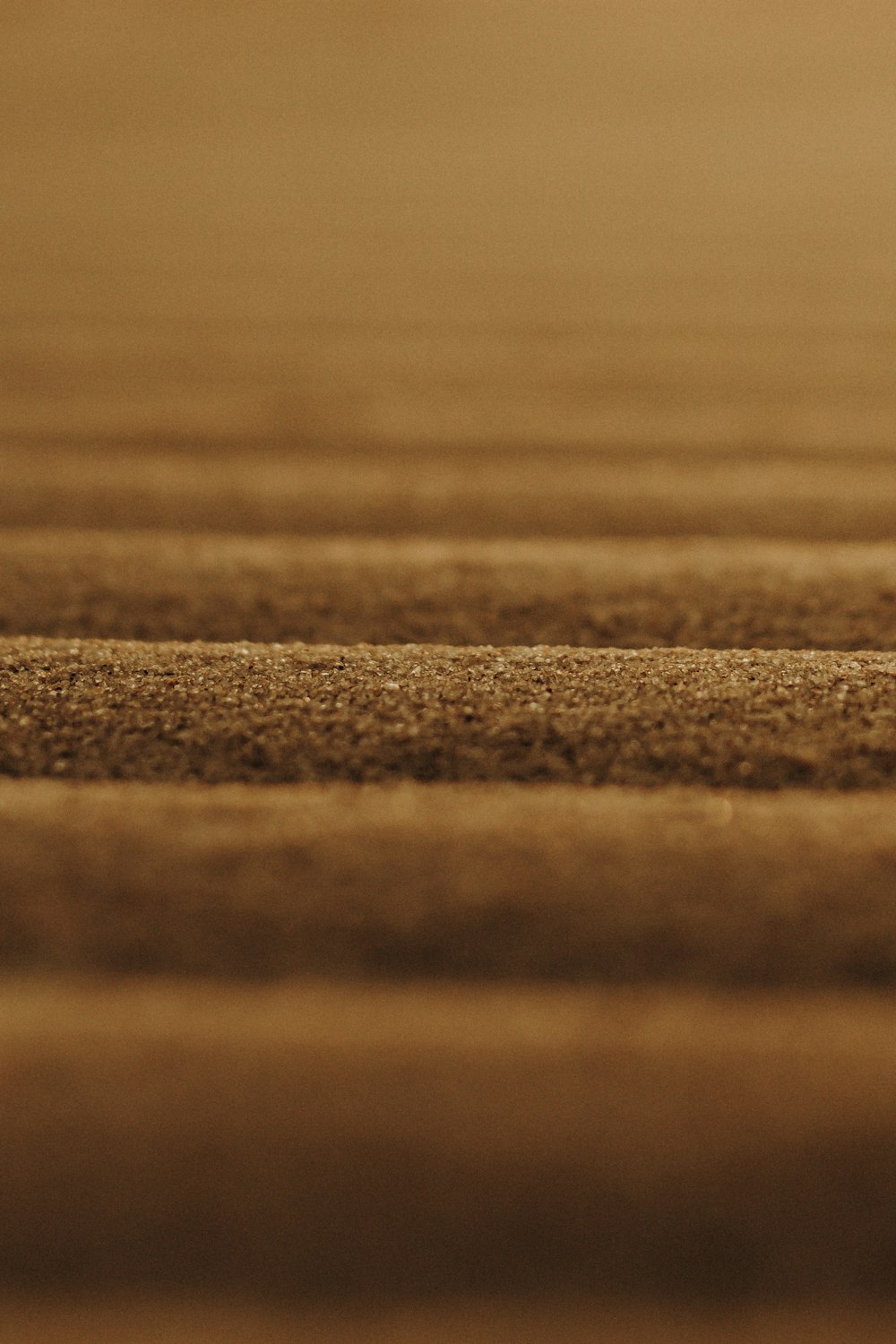 a close up of a wooden surface with a blurry background