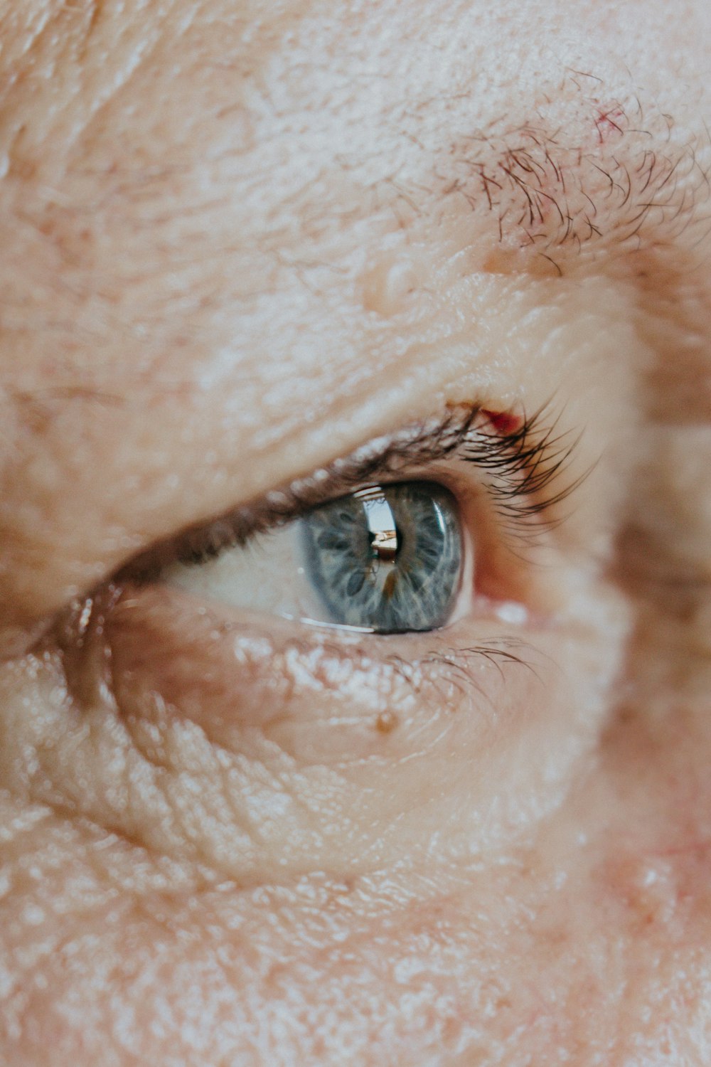 a close up of a person's blue eye