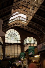 a group of people standing in front of two large windows
