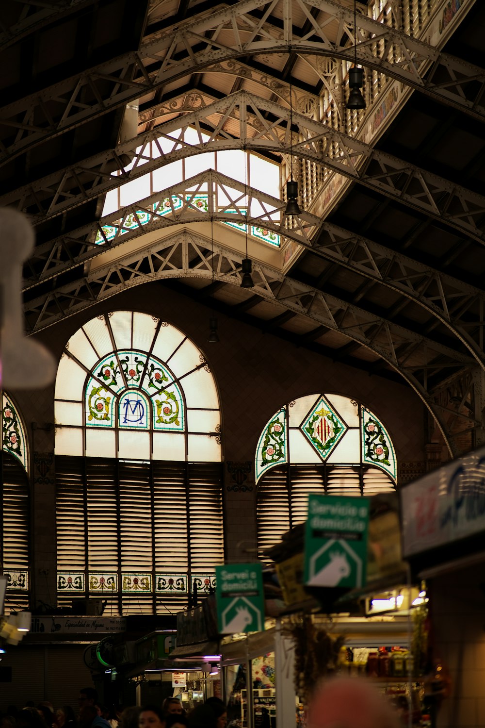 a group of people standing in front of two large windows