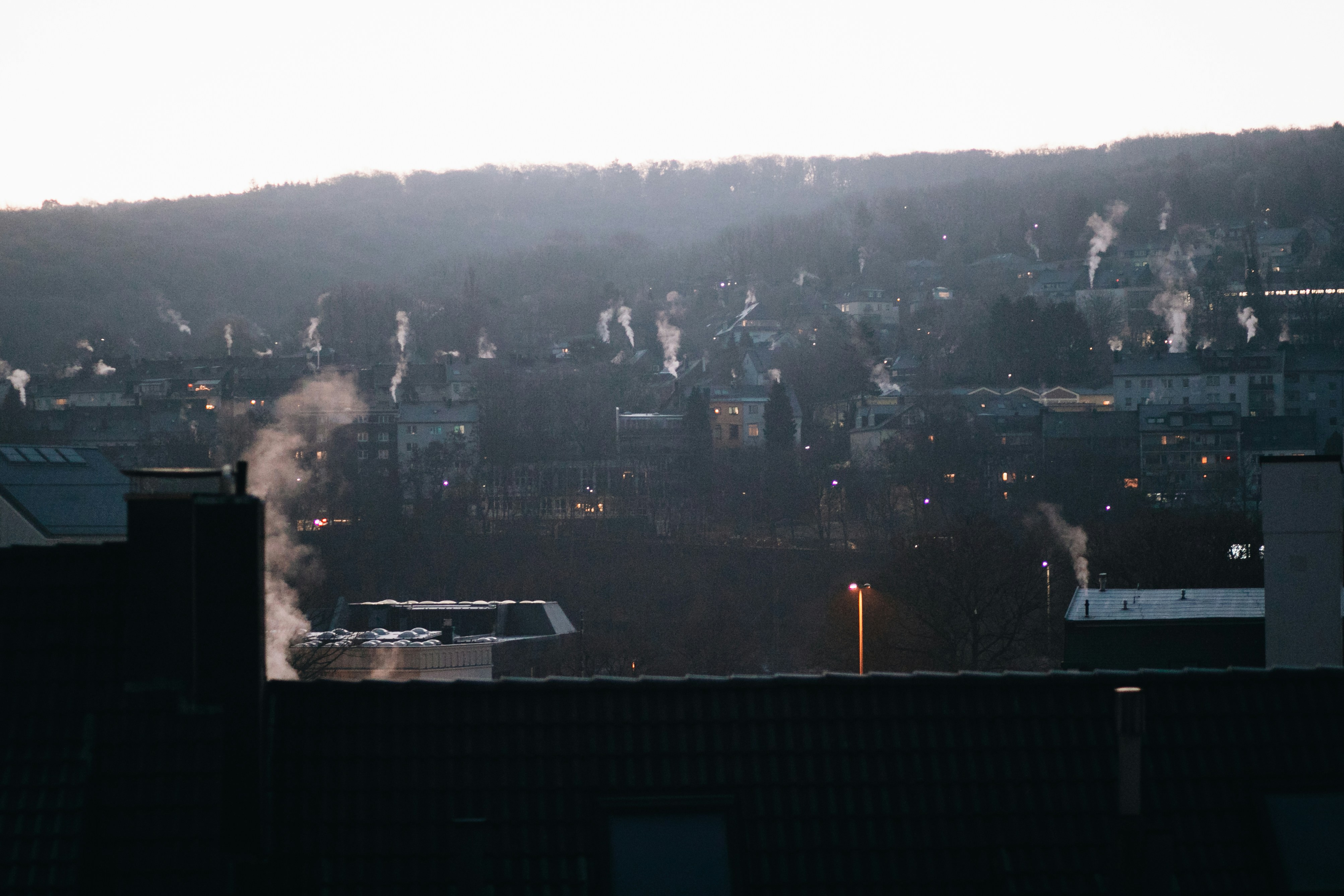 a view of a city with a lot of smoke coming out of it