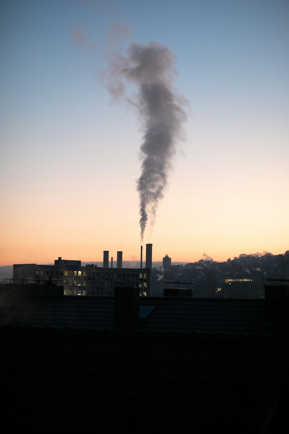 a smokestack emits from the top of a building