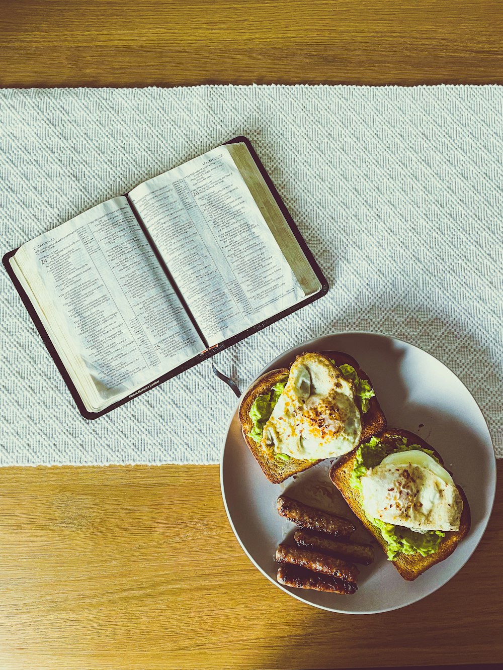 a plate of food and a book on a table