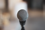 A close-up of a microphone on a wooden table.