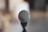 A close-up of a microphone with sound waves emanating from it.