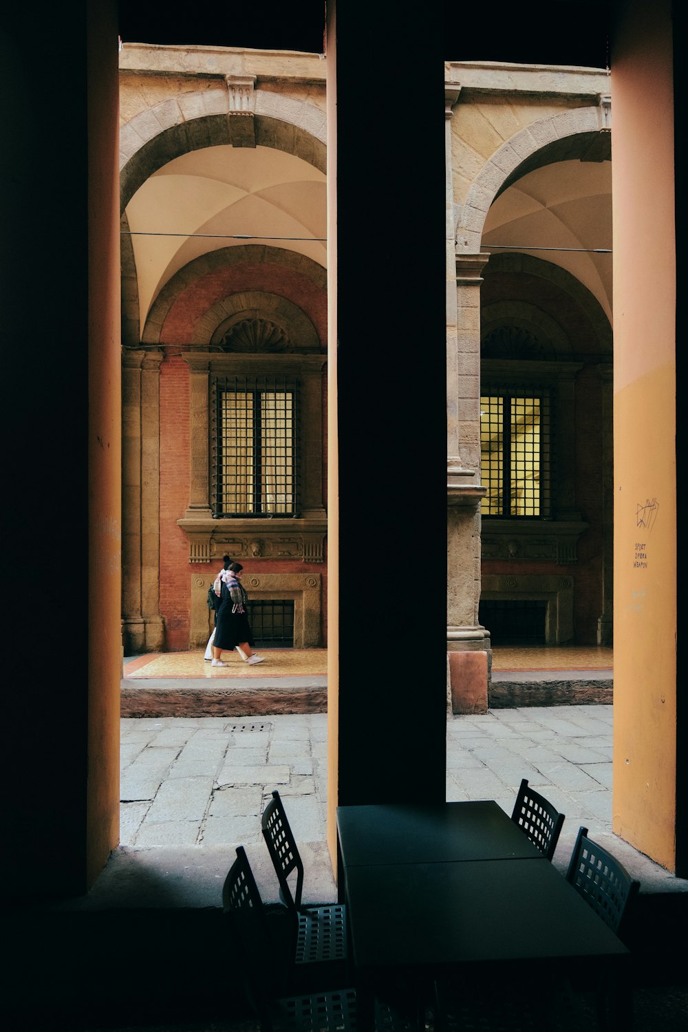 a couple of people standing next to each other near a building