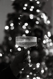 Elegant crystal artisans carefully crafting bespoke glassware in a bright, minimalist workshop.