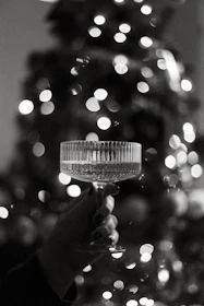 Elegant crystal glassware being carefully crafted in a bright workshop.