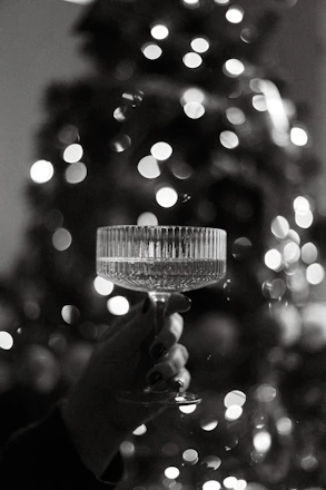 Elegant crystal artisans carefully crafting bespoke glassware in a bright, minimalist workshop.