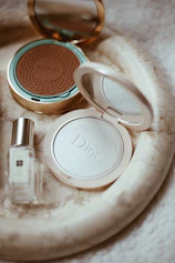 a white tray with a mirror and cosmetics on it