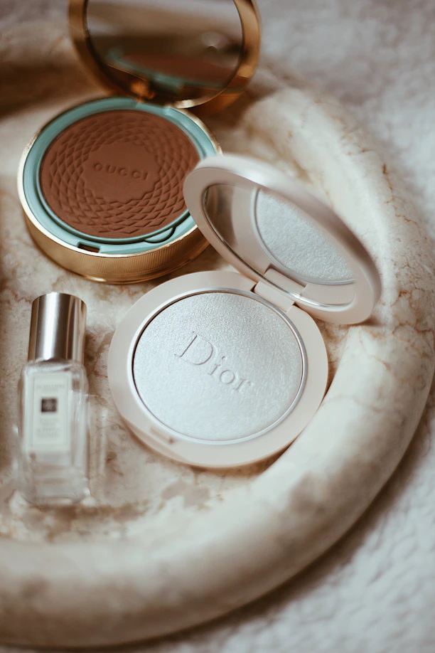 a white tray with a mirror and cosmetics on it