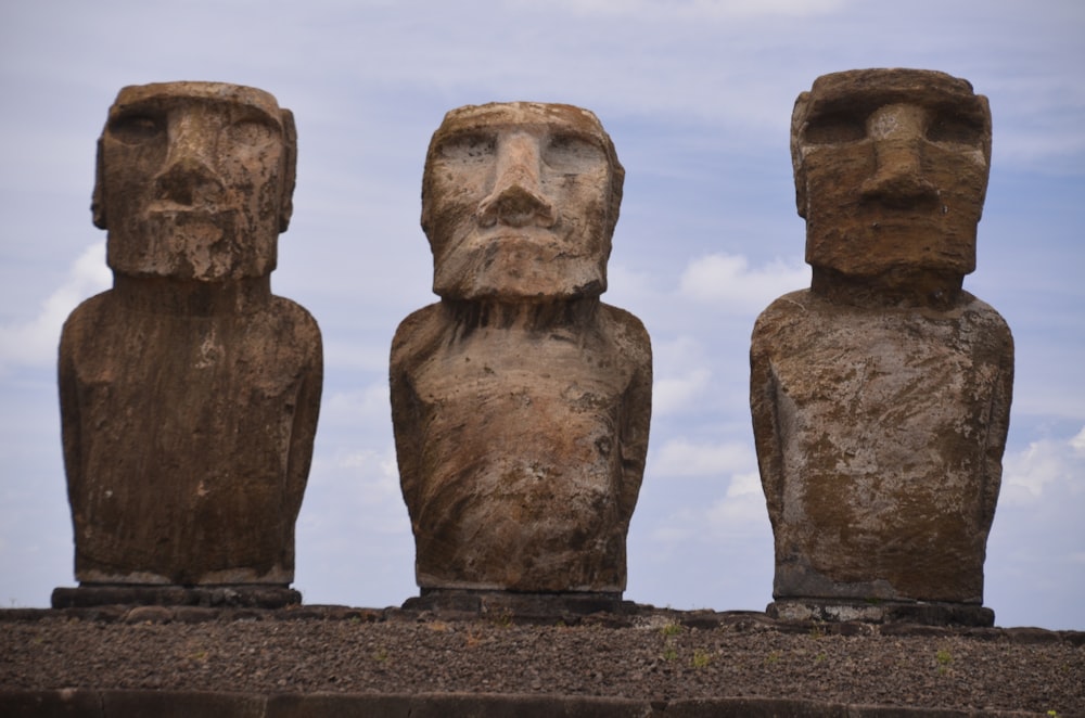 a group of three statues sitting next to each other