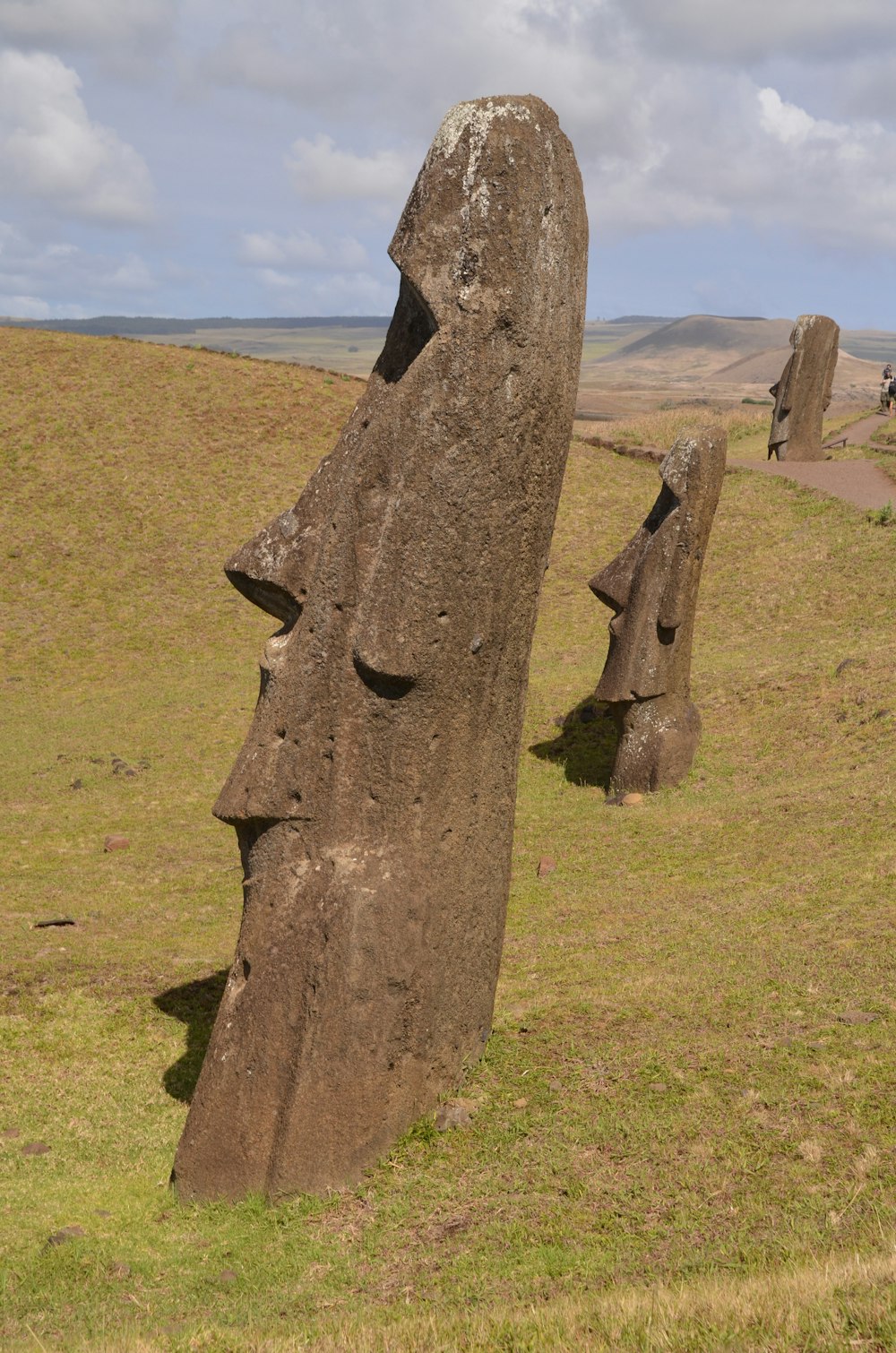 a group of large rocks sitting on top of a grass covered field