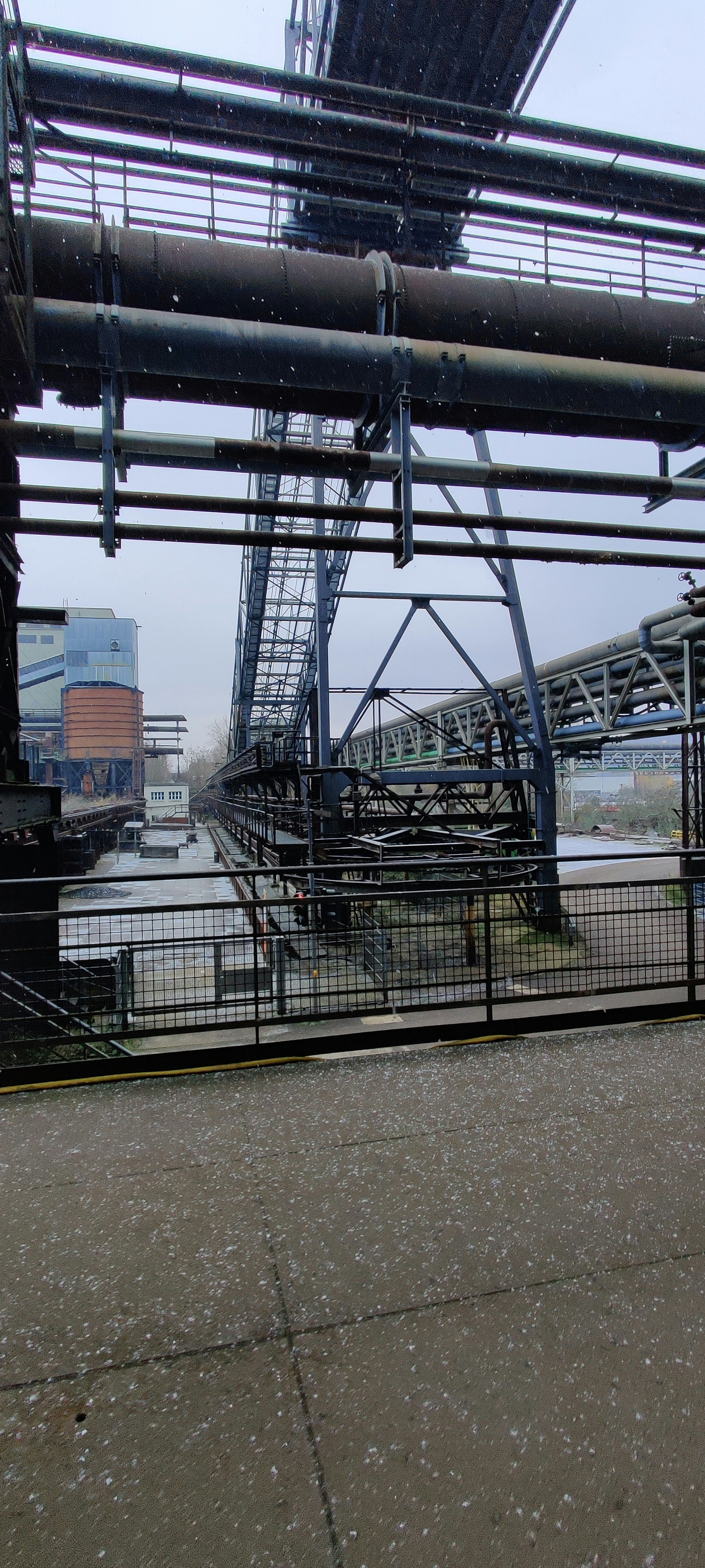 Thermal power station infrastructure with industrial canals and earthwork, dark industrial lighting, heavy machinery, dramatic overcast sky