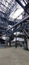 Wide shot of metallic framework being assembled at an industrial construction site.