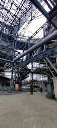 Heavy-duty machinery assembling large metal staircases on site.