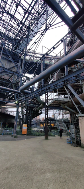 Wide shot of a large steel framework being assembled for an industrial building
