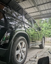 a car is parked under a metal roof