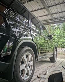 a car is parked under a metal roof