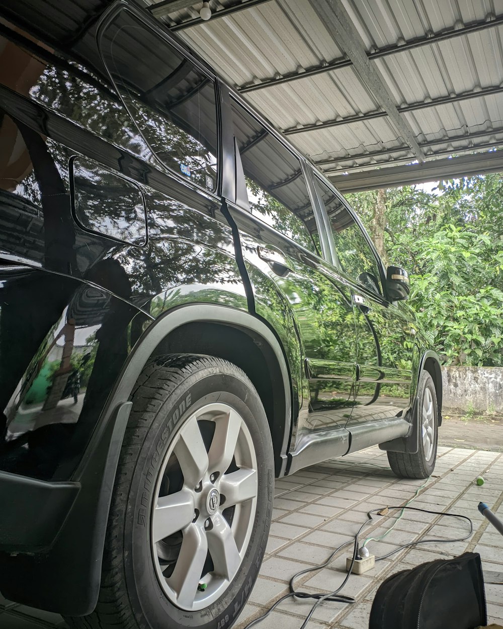 a car is parked under a metal roof