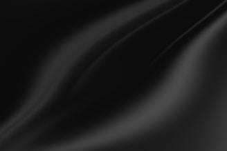 Smooth, flowing curves and gradients in varying shades of black and dark gray create a sense of depth and texture.