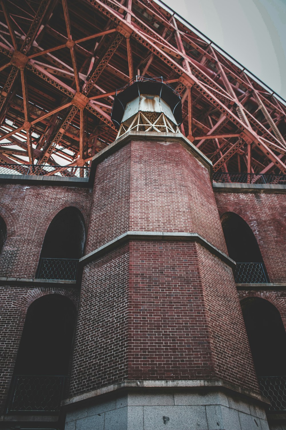 a tall brick tower with a clock on it's side