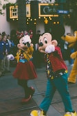 Children laughing while meeting their favorite Disney characters in a bright theme park setting.