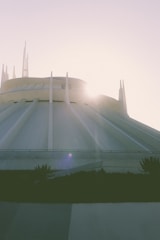 the sun shines brightly on the top of a building