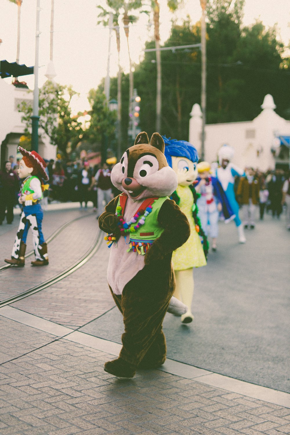 a group of people in costume walking down a street