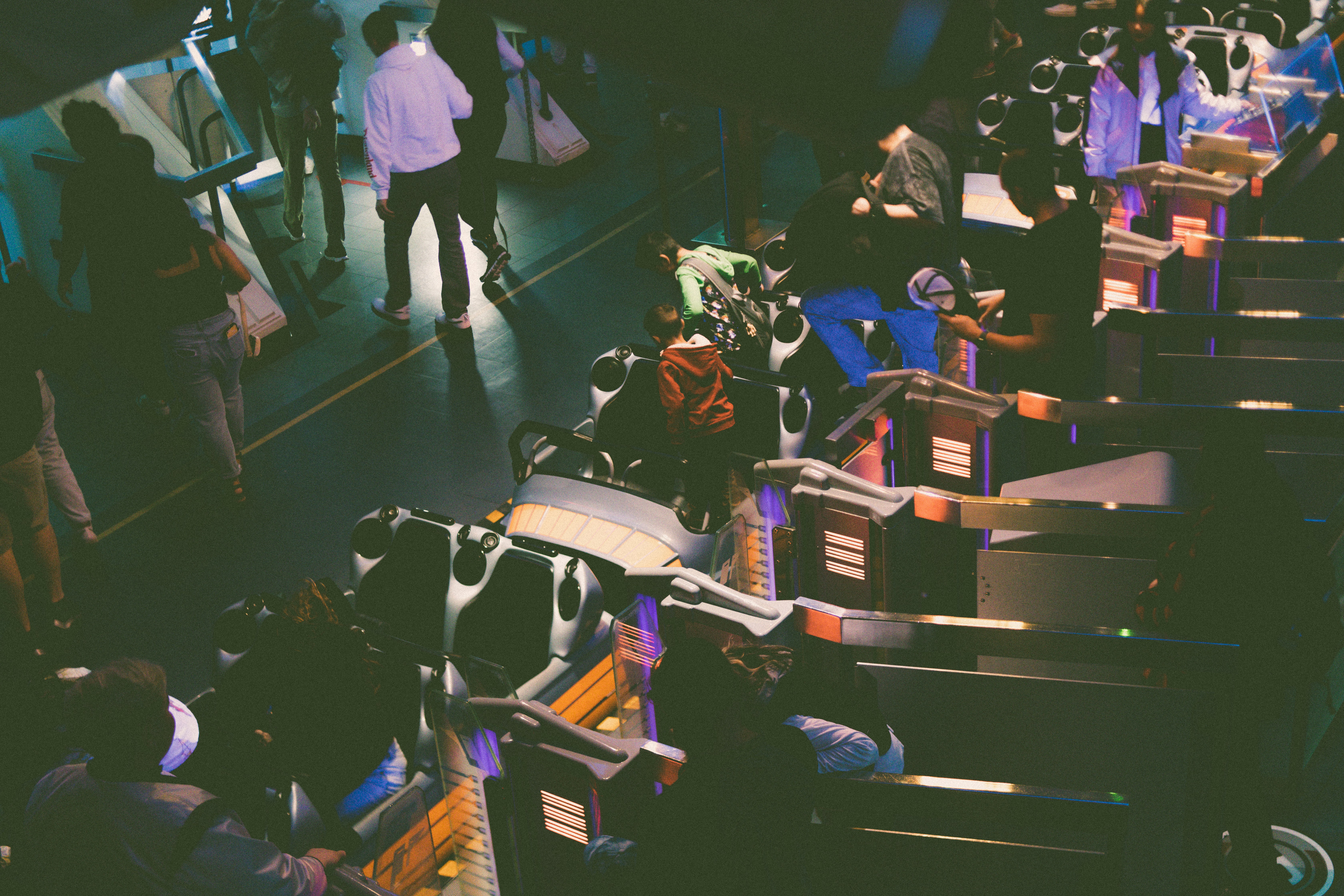 a group of people standing around a baggage claim area