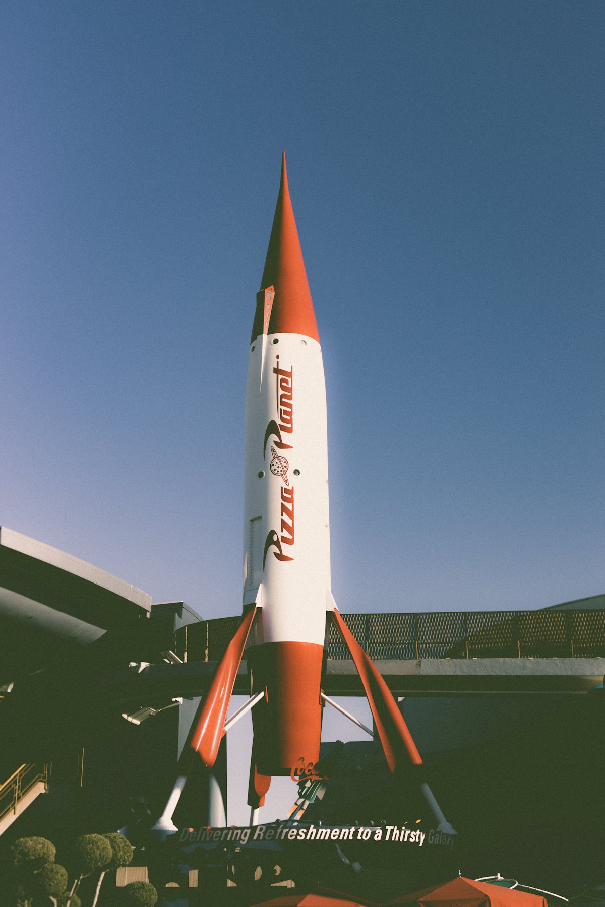 Red and white retro rocket on a building