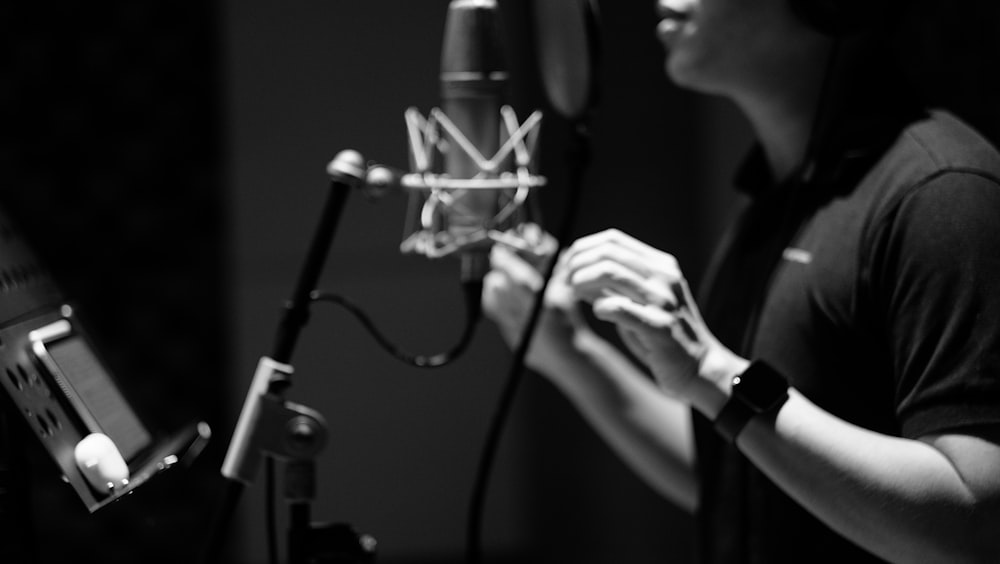 a woman standing in front of a microphone