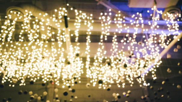 Close-up of a fiber optic ceiling installation with tiny sparkling lights resembling a starry night sky.