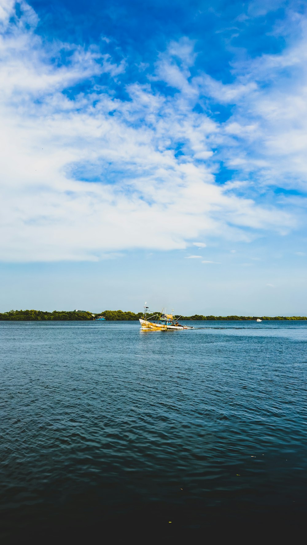 a boat floating on top of a large body of water