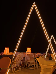 Outdoor evening event with modern structures and subtle golden highlights.