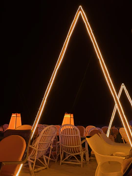 Outdoor evening event with modern structures and subtle golden highlights.