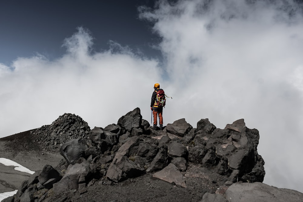 a man standing on top of a rocky mountain