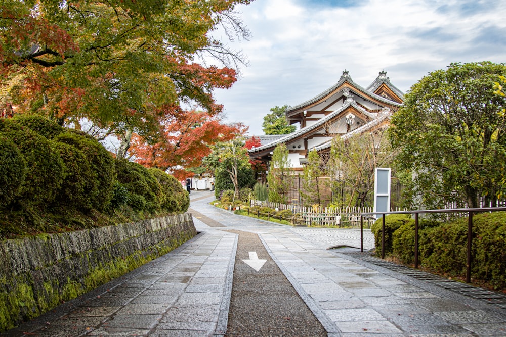 a stone path leading to a building with a clock tower in the background