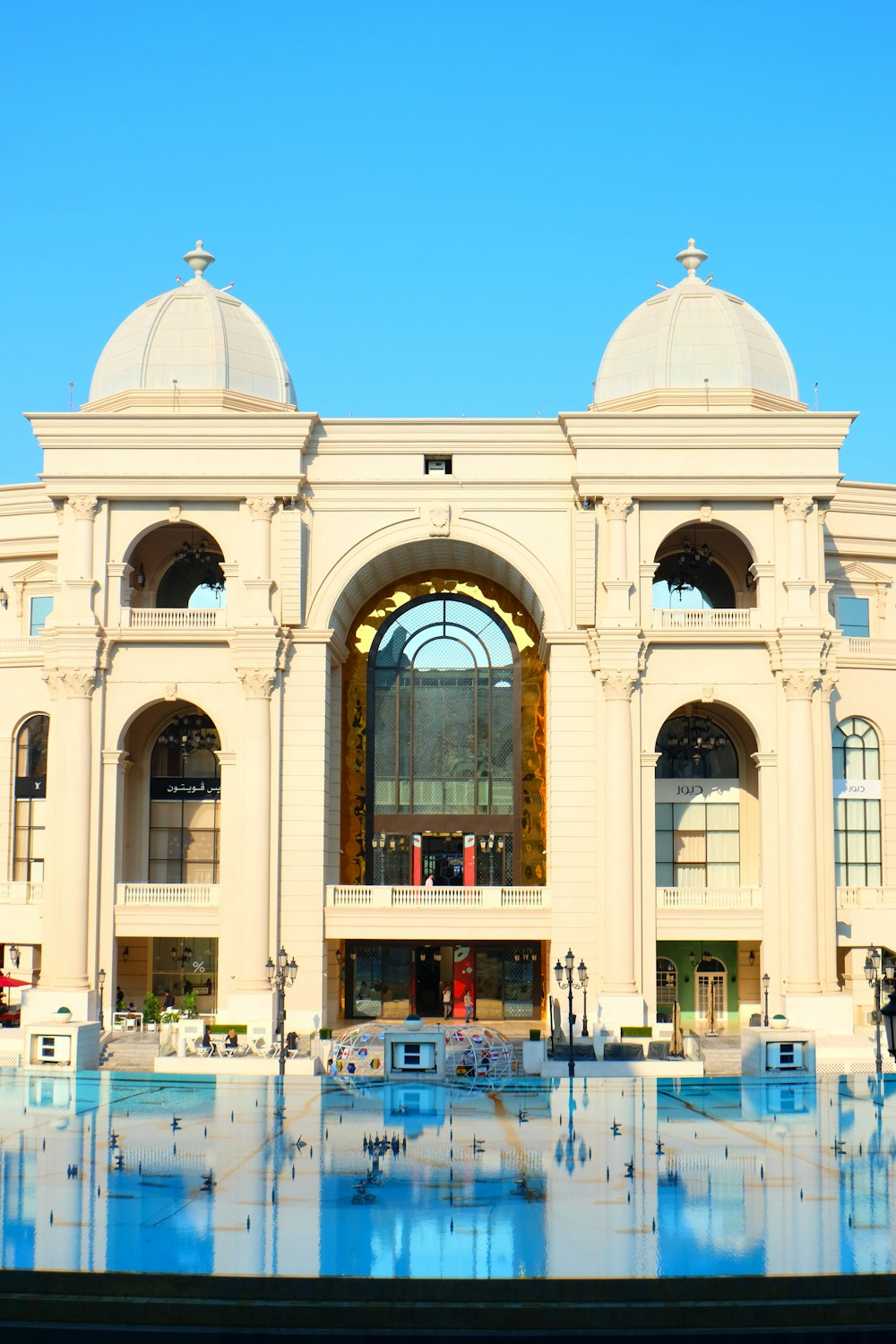 a large building with a pool in front of it