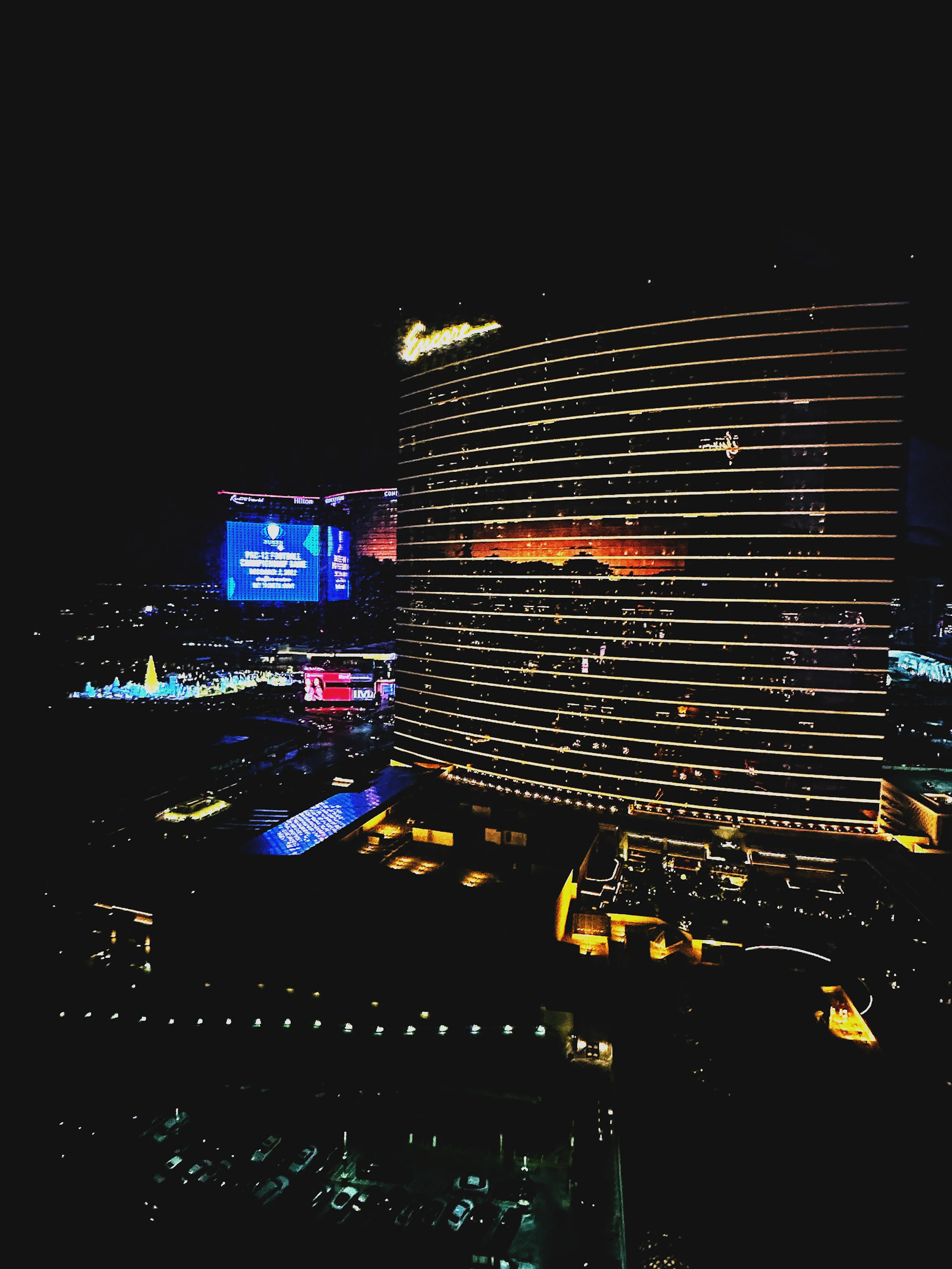 Elegant cityscape at night showcasing a high-end hotel with illuminated windows and a sleek modern design.