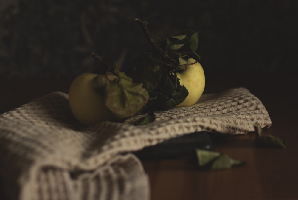 a couple of apples sitting on top of a table