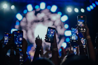 a group of people holding up their cell phones