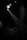 A dimly lit scene with a spotlight shining down at an angle, illuminating part of a dark room. A round table is set up with several chairs around it, and there are a few visible people. The lighting creates a dramatic and focused effect, highlighting the table setup in an otherwise shadowy environment.