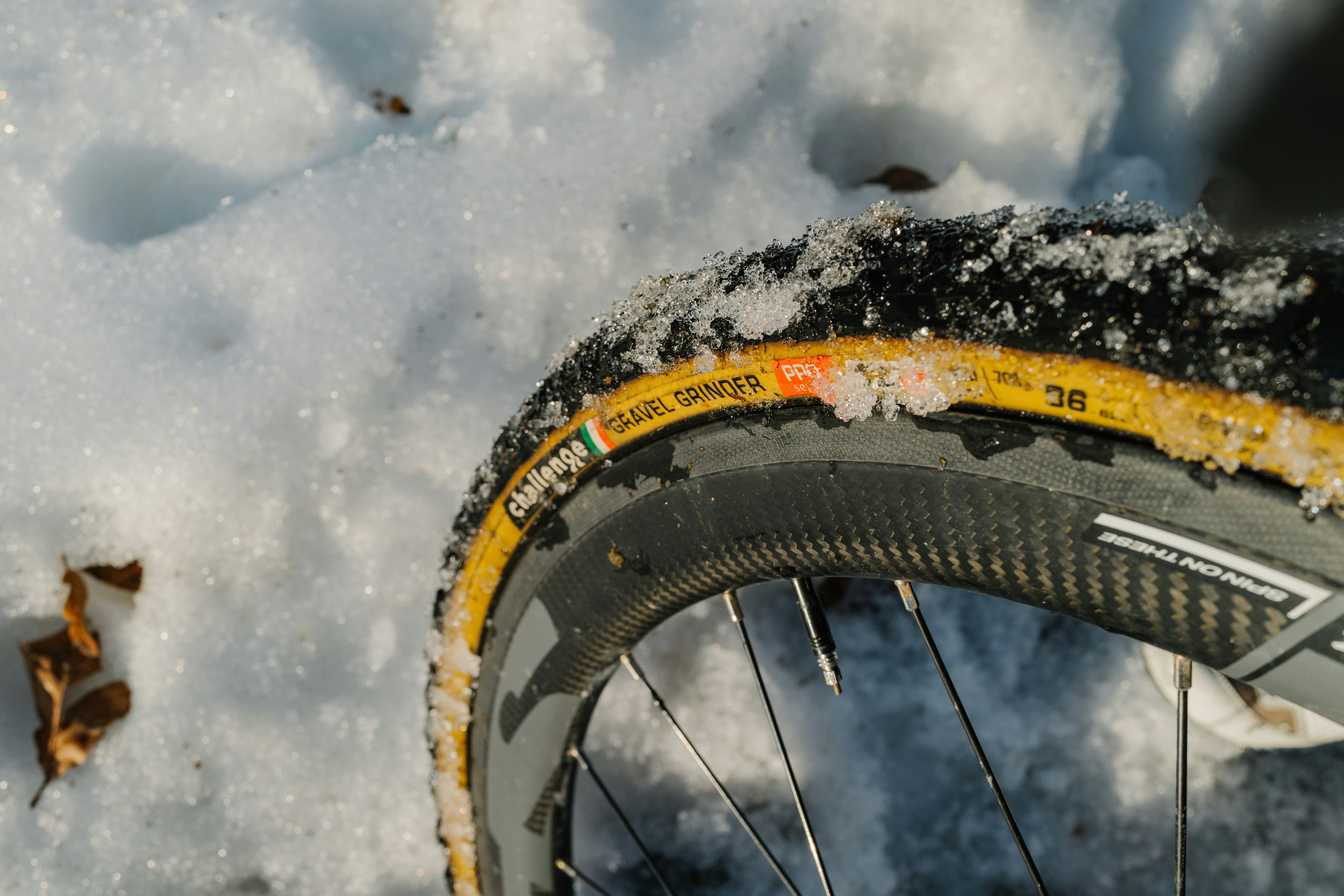 A close up of a bike tire in the snow photo Free Wheel Image on Unsplash
