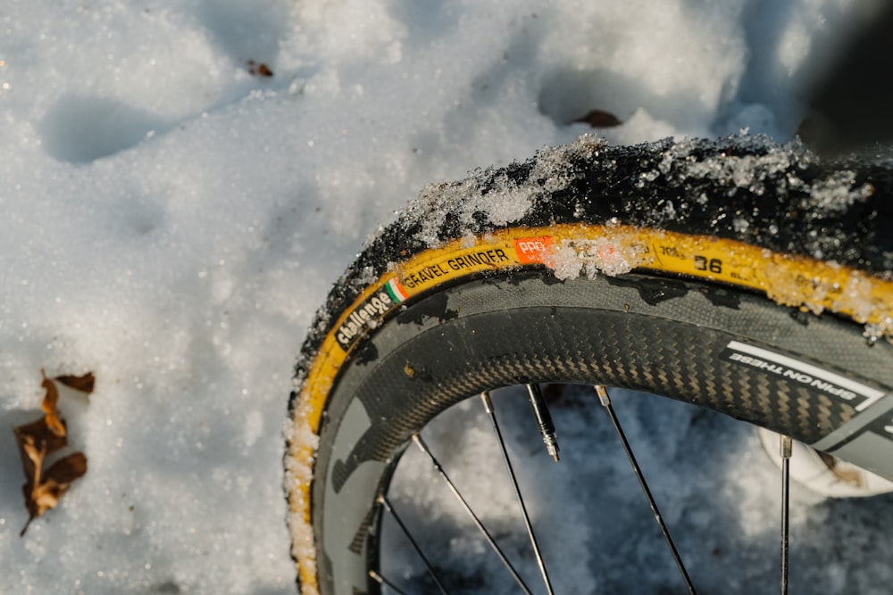 a close up of a bike tire in the snow