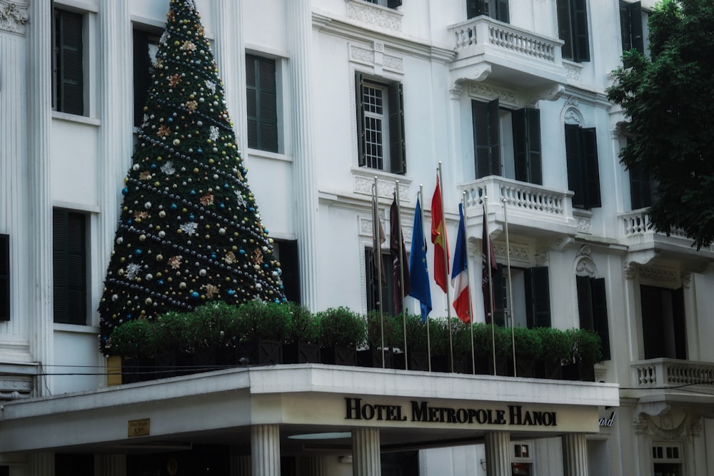 a hotel with a christmas tree in front of it