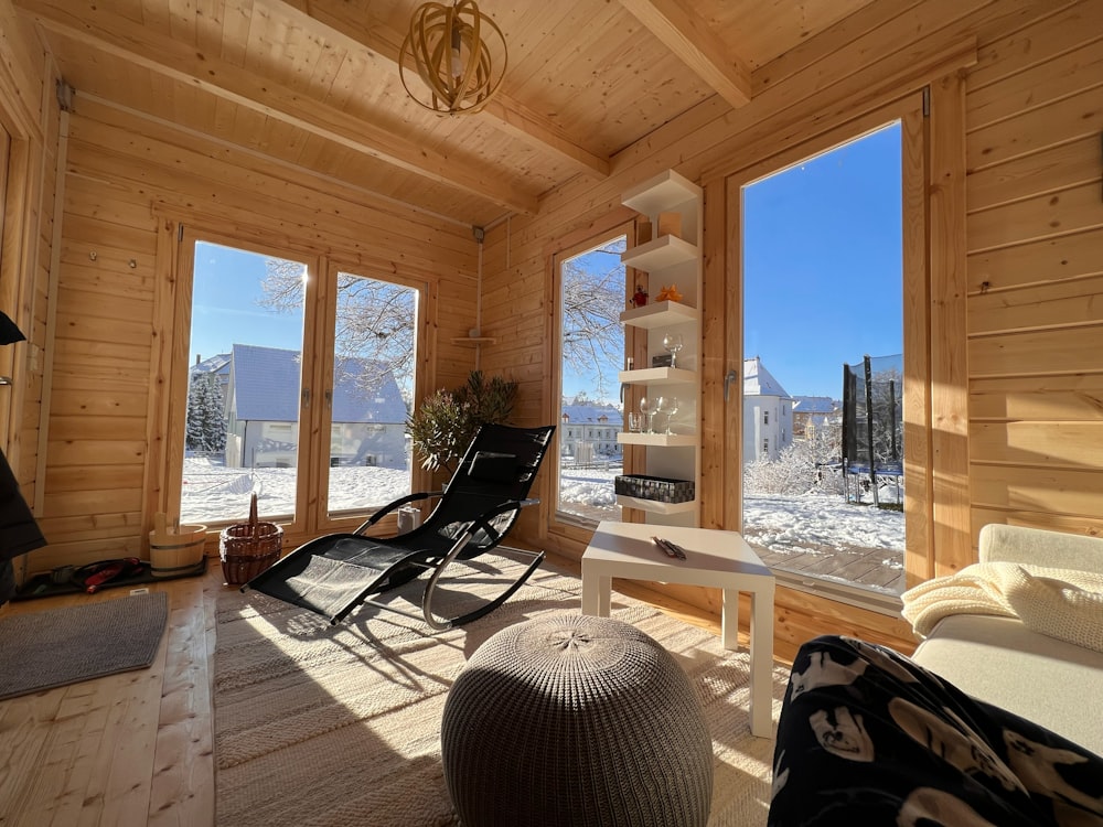 a living room filled with furniture and lots of windows