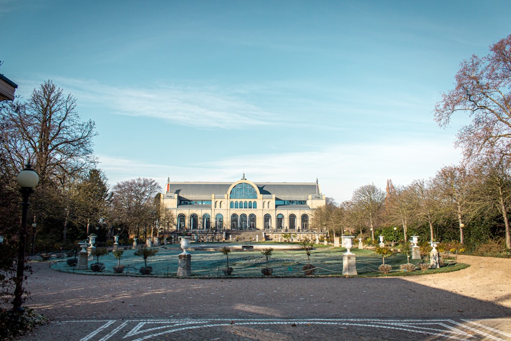 a large building sitting next to a lush green park